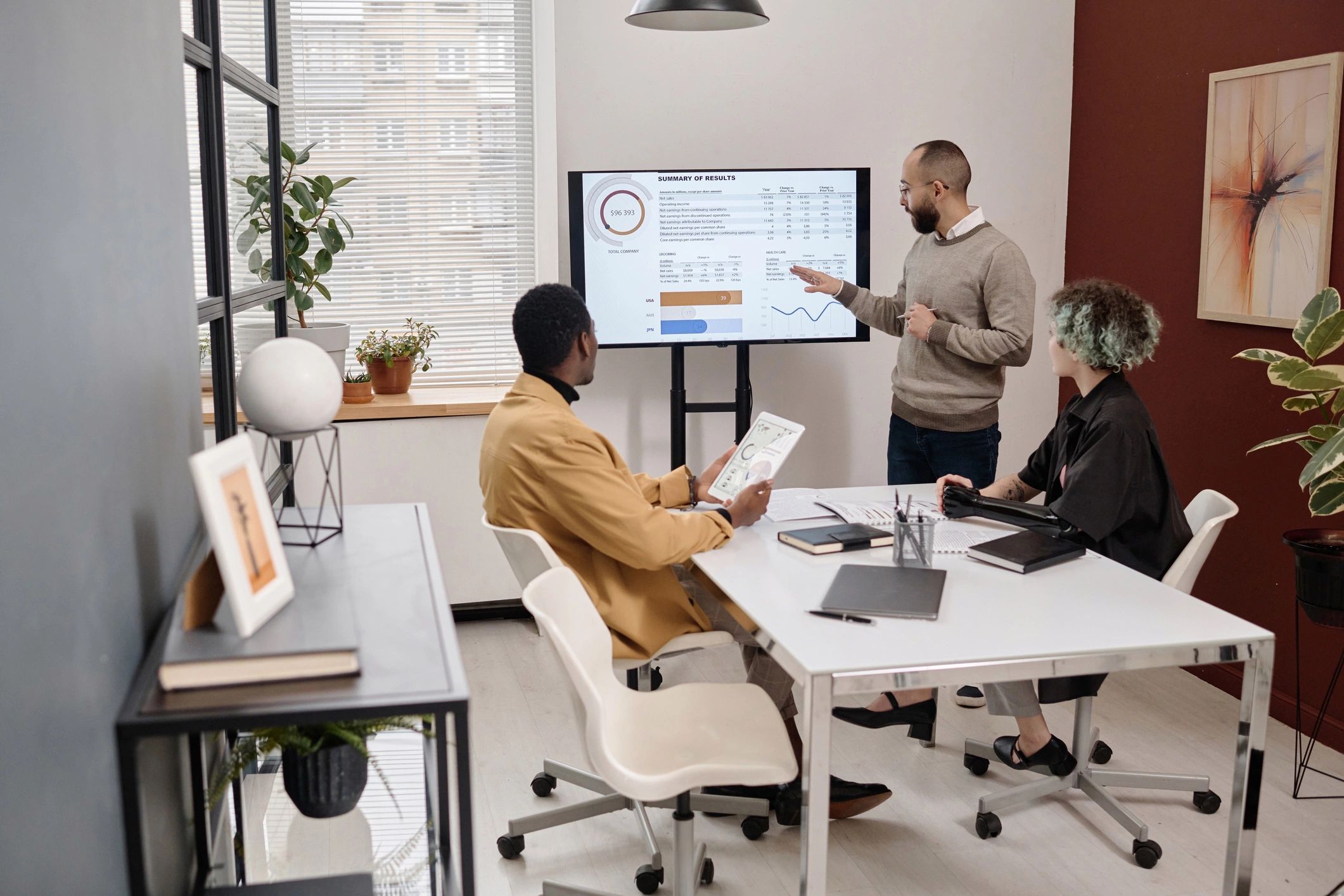 Young office employees working together on charts and graphs